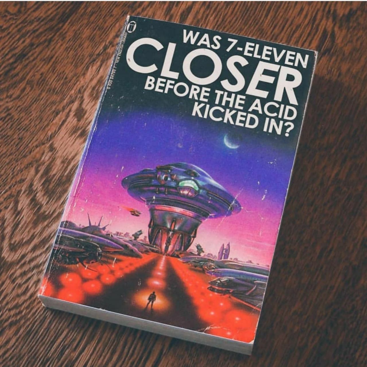 a book on a table with a spaceship in the background